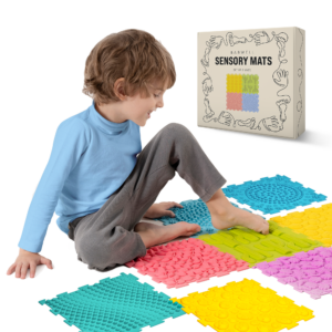child sitting on babwell sensory mats for autistic children
